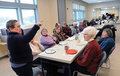 TERRI ARNOLD, DIRECTOR of the Middlebury Recreation Department, welcomes seniors to the first senior luncheon at the town’s new recreation center now open on Creek Road. Independent photo/Trent Campbell